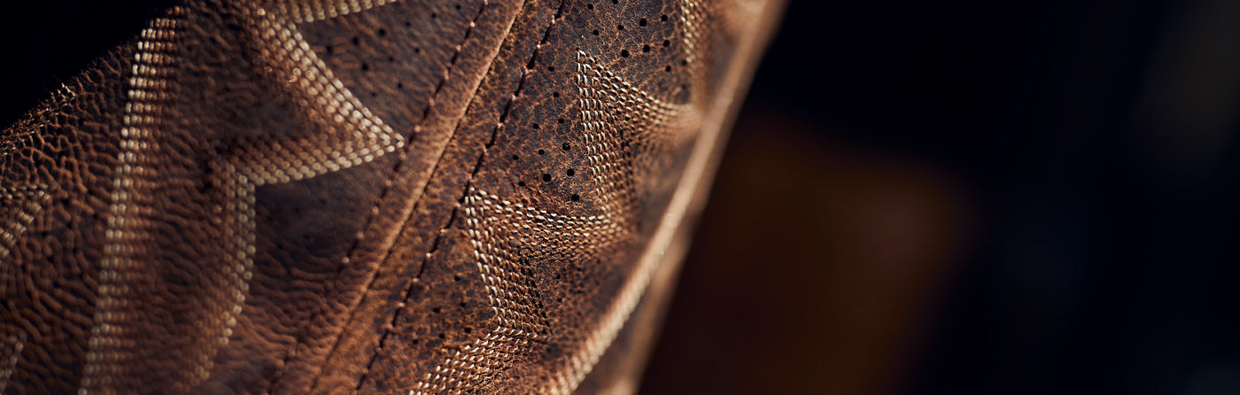 Close up texture of a Durango boot on a black background